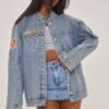 Prettylittlething Mid Blue Wash Racer Graphic Oversized Denim Jacket Mid Blue Wash